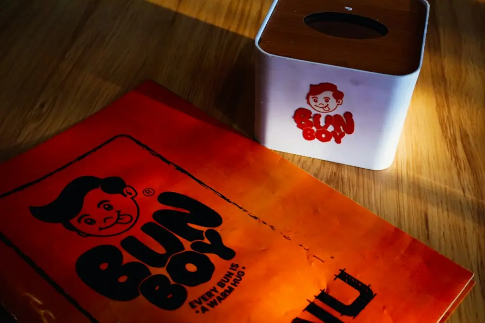Bun boy branding on orange paper and tissue box
